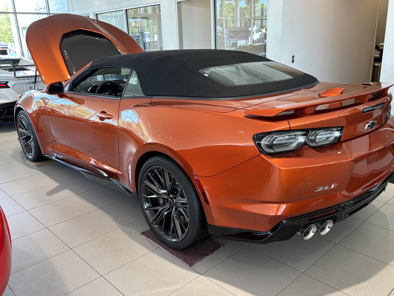 Orange 2024 Chevrolet Camaro ZL1 Convertible on the showroom floor at Crivelli Chevrolet Buick in Mount Pleasant, PA